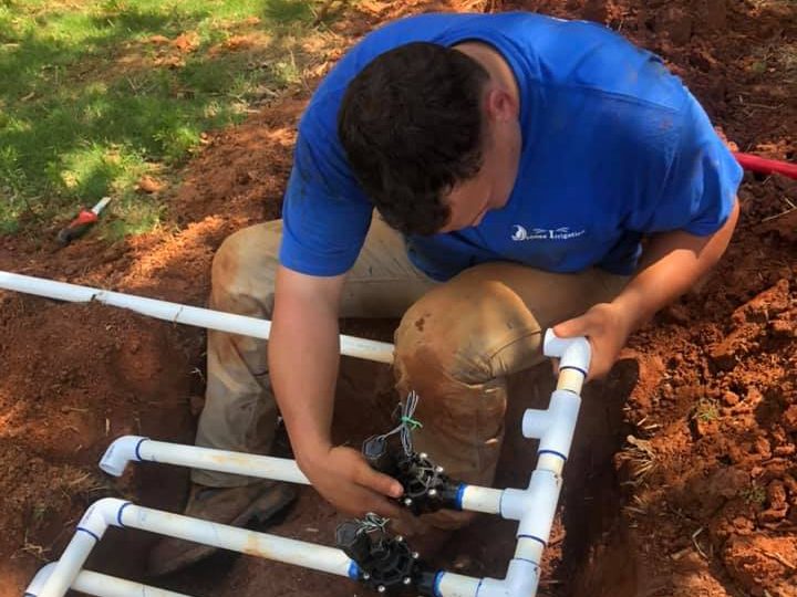 man installing irrigation system