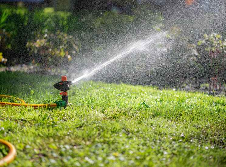 Automatic sprinkler system watering the lawn of a property